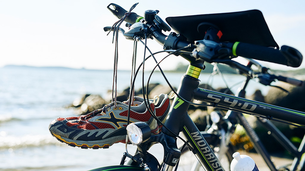 Bike with map and running shoes