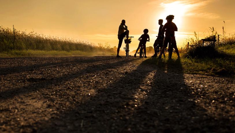 Family on a biking trip at sunset