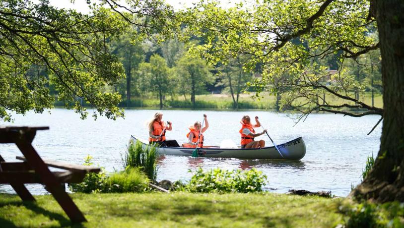 Family in a canoe on the river Gudenå in Denmark