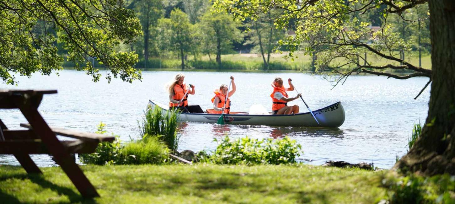 Family in a canoe on the river Gudenå in Denmark