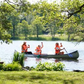 Family in a canoe on the river Gudenå in Denmark